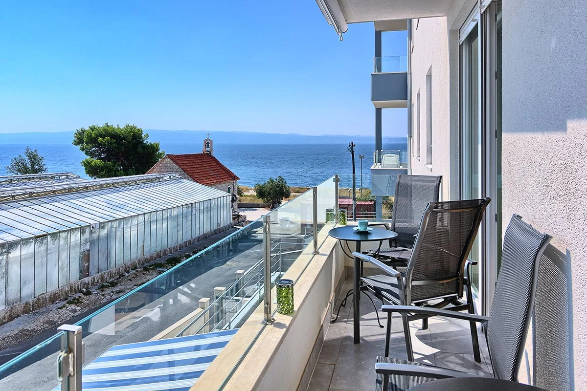 Private apartment balcony with chairs and sea view